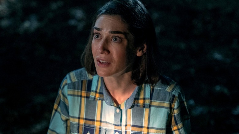 Annie standing in the dark woods frowning in "Castle Rock."