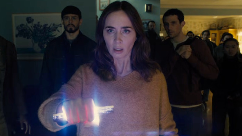 Margaret holding a glowing alien device in Disclosure Day