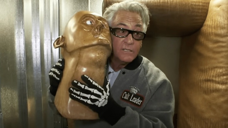 Barry Weiss holding weird statue