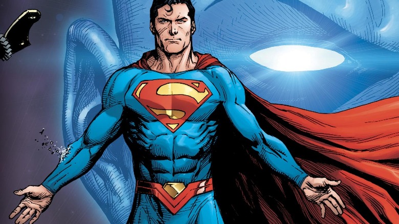Dr. Manhattan towering behind Superman