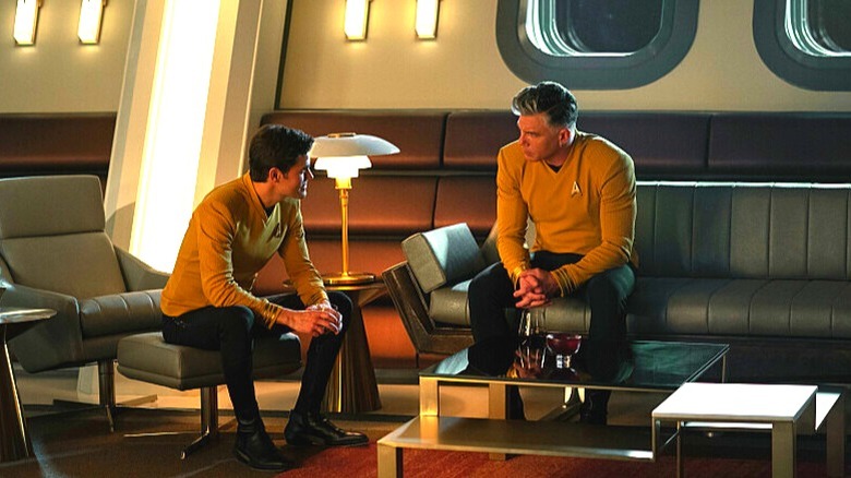 Captain Kirk and Captain Pike deep in discussion