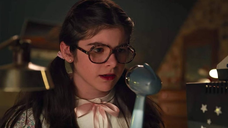 Suzie talking into a microphone in Stranger Things