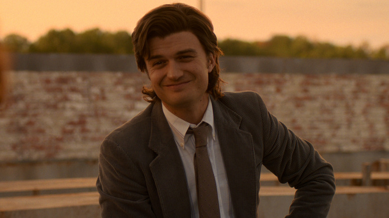 Steve Harrington smiles at his friends in "Stranger Things"