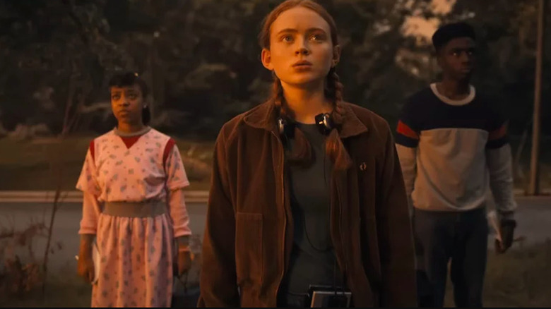 Max, Erica, and Lucas from Stranger Things looking serious