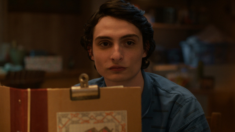 Mike looking over his D&D folder on "Stranger Things" (2016-2025)