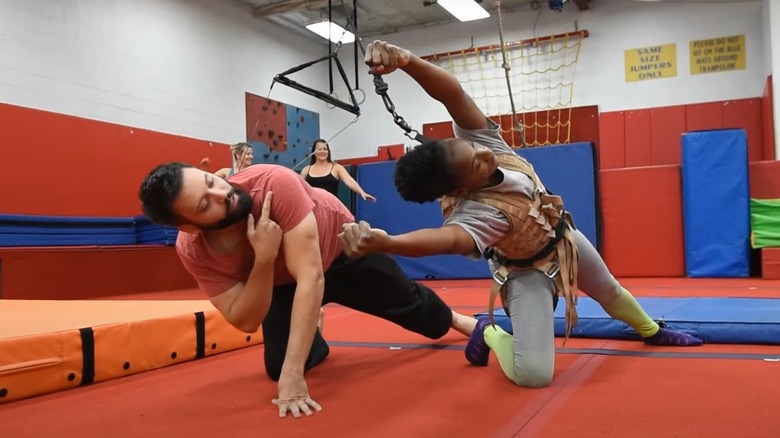 An actor being trained in stunt work
