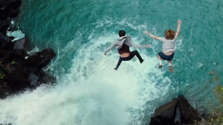 Zach and Gray Mitchell jump into a waterfall pursued by Indominus Rex Jurassic World