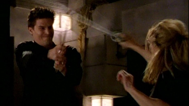 David Boreanaz as Angellus and Sophia Crawford as Buffy swordfight in Buffy the Vampire Slayer
