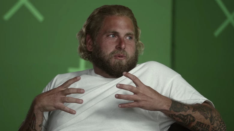 Jonah Hill mid-sentence on a green screen