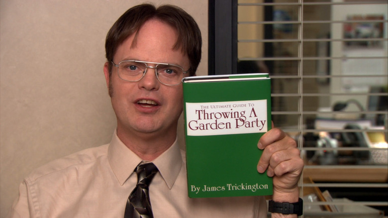 Dwight Schrute holding book