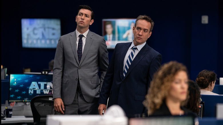 Tom Greg standing in newsroom