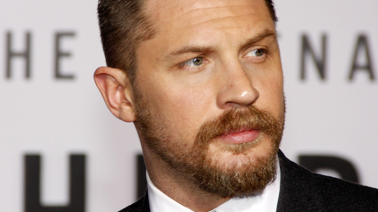 Tom Hardy looks to the side