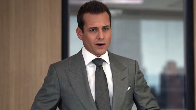 Harvey standing in a suit