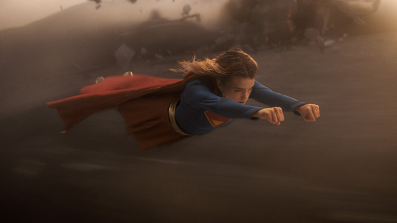 Supergirl flying into battle with both arms out in front of her in Supergirl (2026)