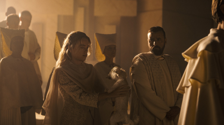 Kara Zor-El holding Krypto at a Kryptonian ceremony with her father in Supergirl (2026)
