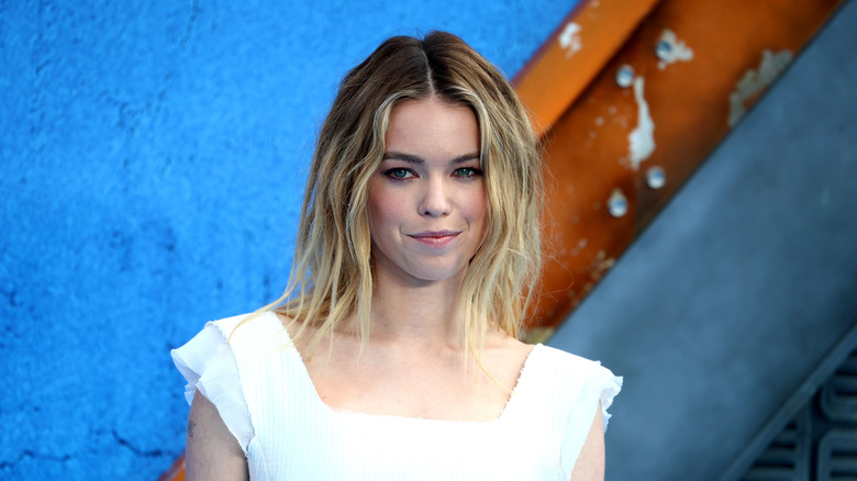 Milly Alcock posing for photos on the Supergirl red carpet (2026)
