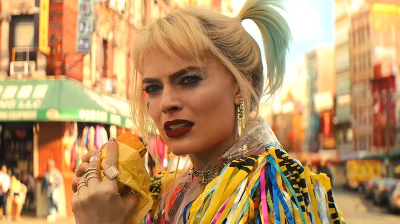 Harley Quinn holding breakfast sandwich in 