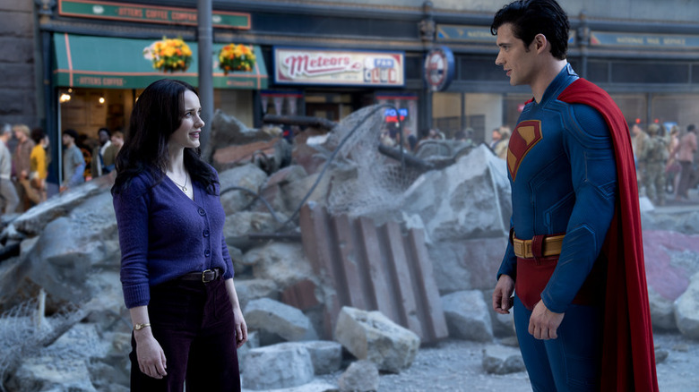 Superman stands with Lois Lane among wreckage in "Superman" (2025)