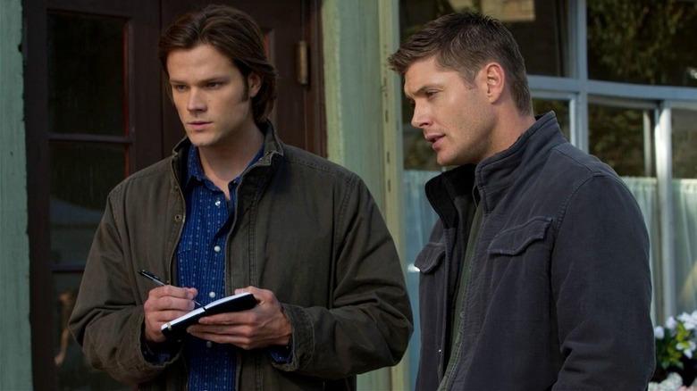 Sam and Dean Winchester taking notes in Supernatural