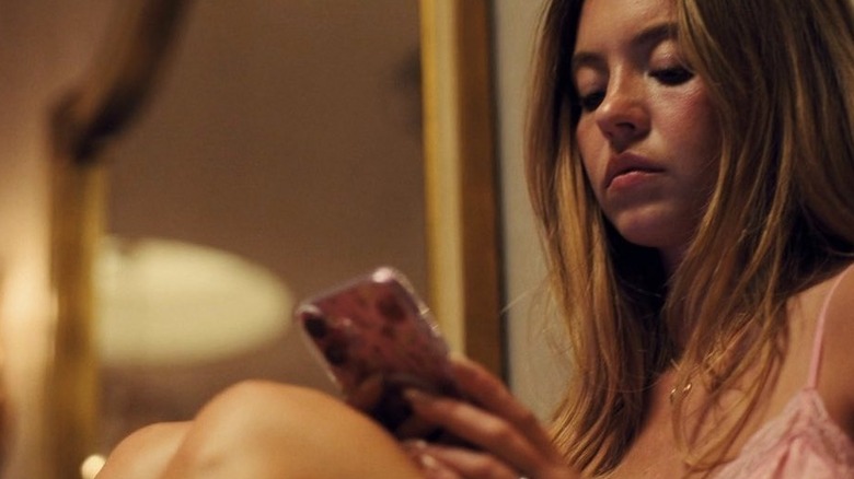 Cassie looking down at her phone on Euphoria