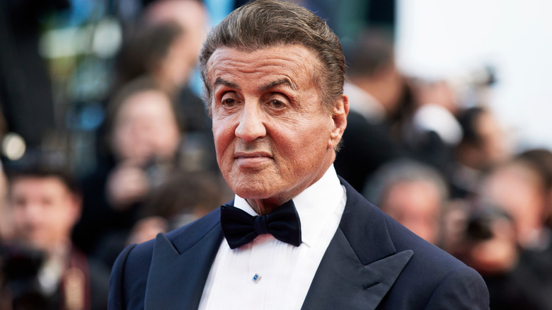 Sylvester Stallone eyebrows raised wearing tuxedo