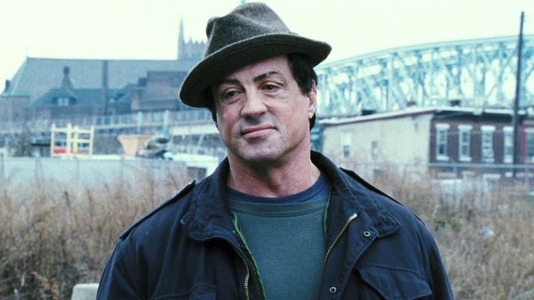 Rocky Balboa smiling outside with hat