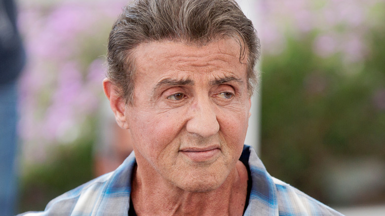 Sylvester Stallone smiling off camera