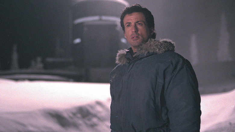 Jake stands in snow furrowing his brow in D-Tox