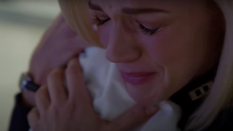 Sylvie cradling Amelia crying
