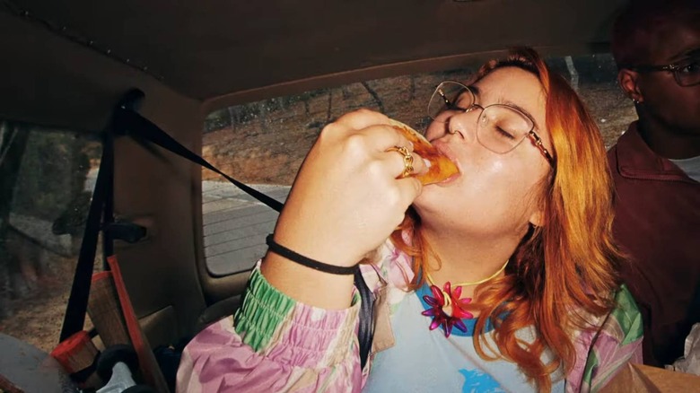 Woman eating grilled cheese dipping taco