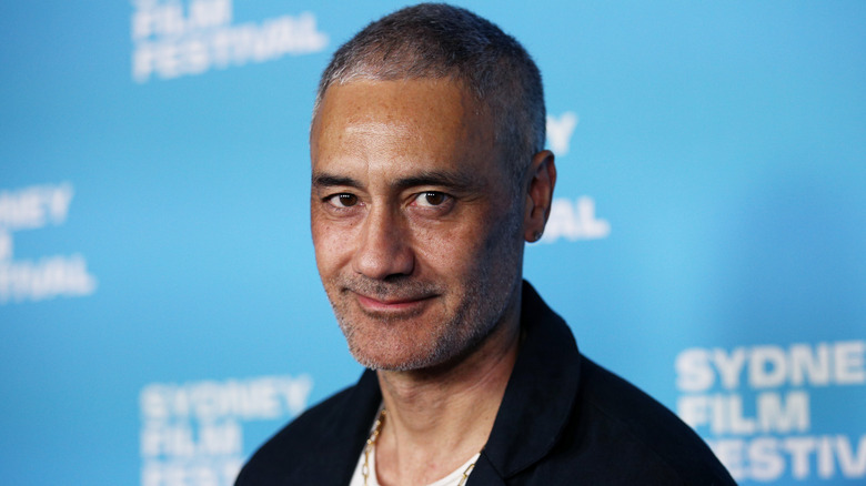 Taika Waititi at event smiling