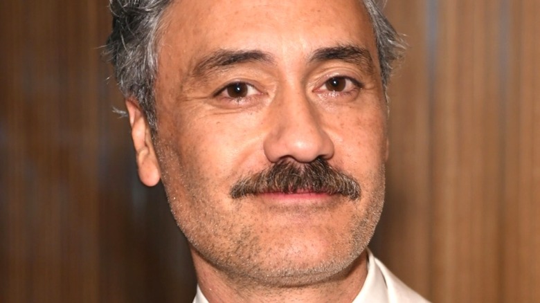 Taika Waititi sports a mustache and smiles