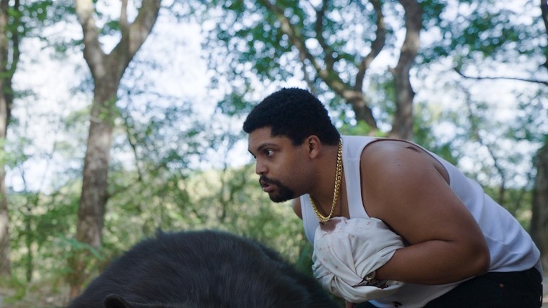 Cocaine Bear O'Shea Jackson Jr. handling unconcious bear
