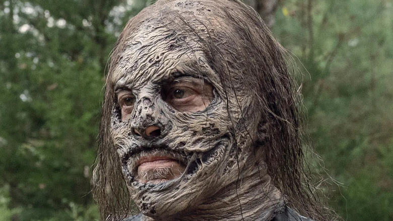 Negan wearing a whisperer mask