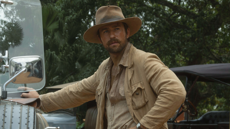 Spencer standing next to a car