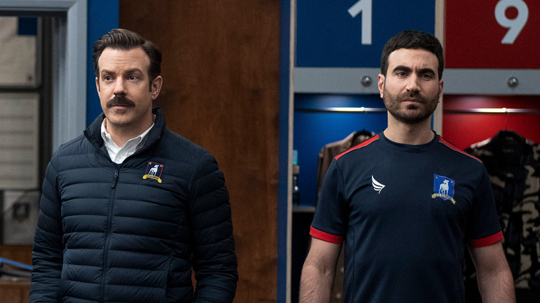 Ted and Roy standing in locker room 