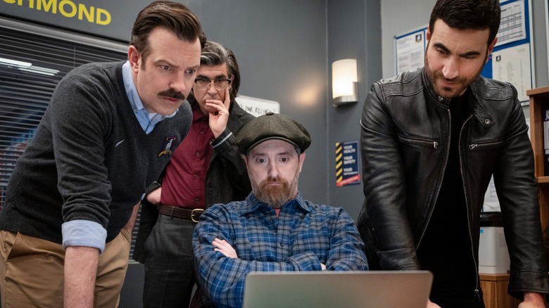 Ted, Trent, Beard, and Roy watching laptop