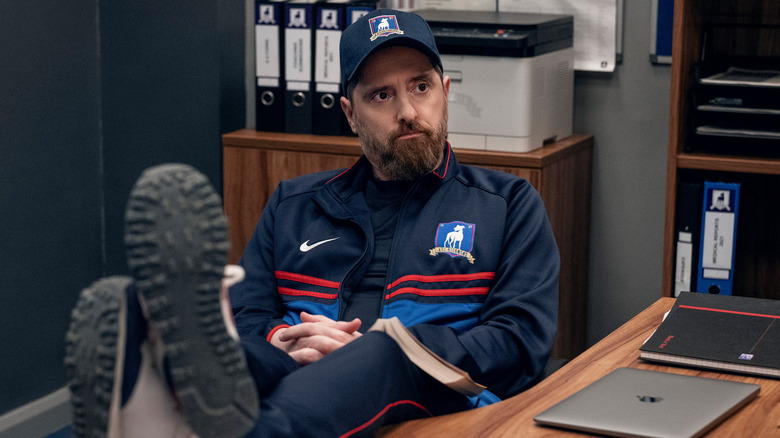 Coach Beard with feet on desk