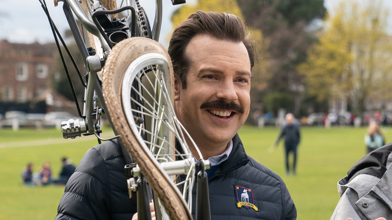 Ted holding a ruined bicycle