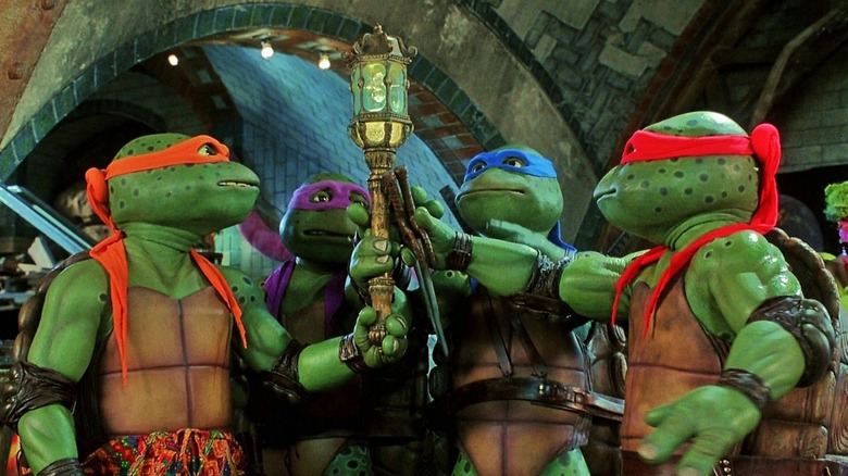 The Turtles toasting their trinkets in "Teenage Mutant Ninja Turtles III" (1993)