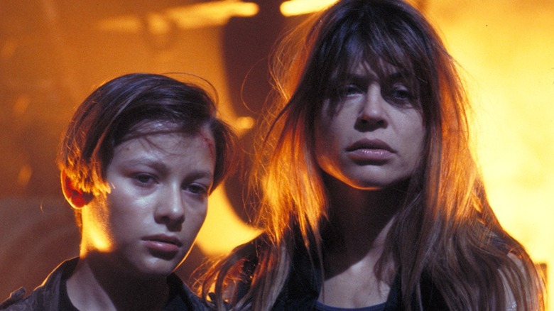 John and Sarah standing together in front of fire in Terminator 2