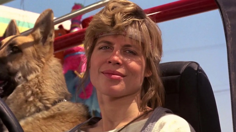 Sarah Connor smiling in her car with her dog in The Terminator