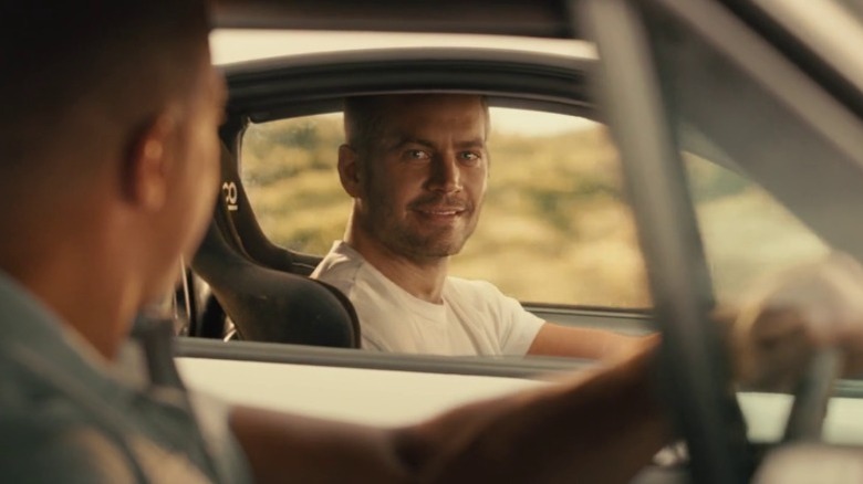 Brian O'Conner smiles at Dominic Toretto in "Furious 7" (2015)