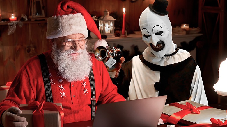 Santa reading his list next to Art the Clown