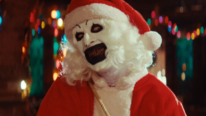 Art the Clown terrifying a mall Santa with a leaf blower in Terrifier 3