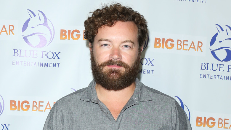 Danny Masterson poses in front of a white backdrop