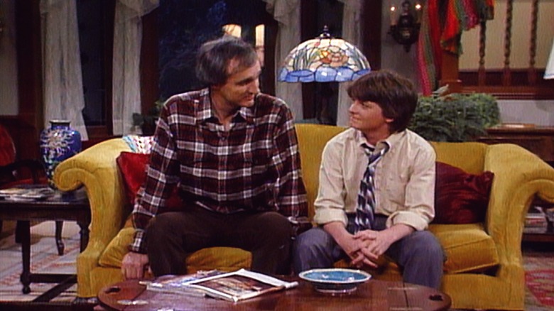 Steven and Alex P. Keaton talking on the couch in "Family Ties"