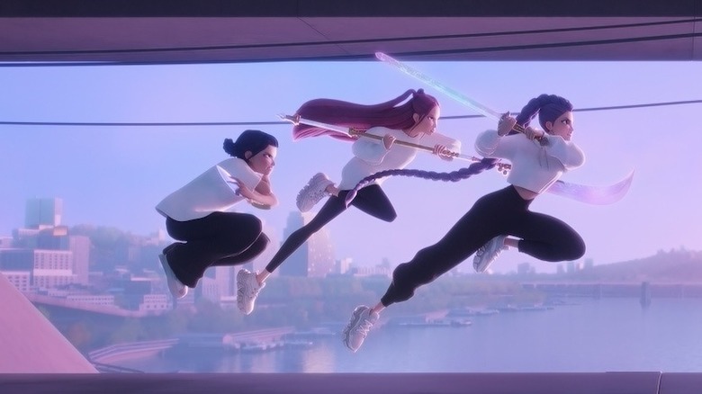 Huntr/x take on a group of demons on top of a train in KPop Demon Hunters