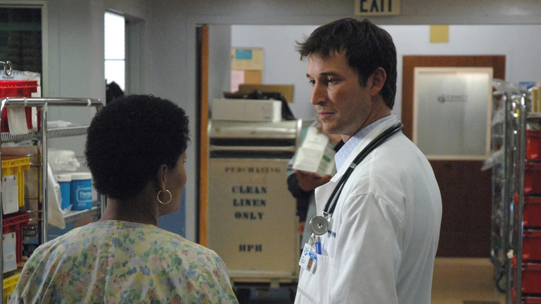John Carter talking to someone in a hallway on ER