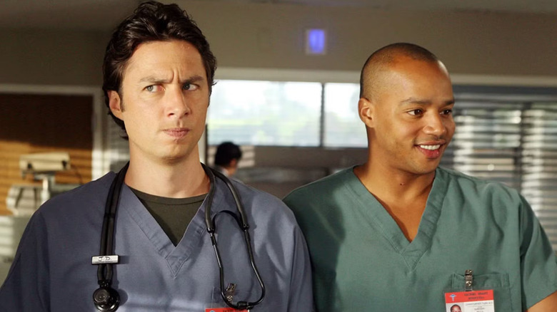 J.D. daydreaming and Turk smiling both wearing scrubs on Scrubs